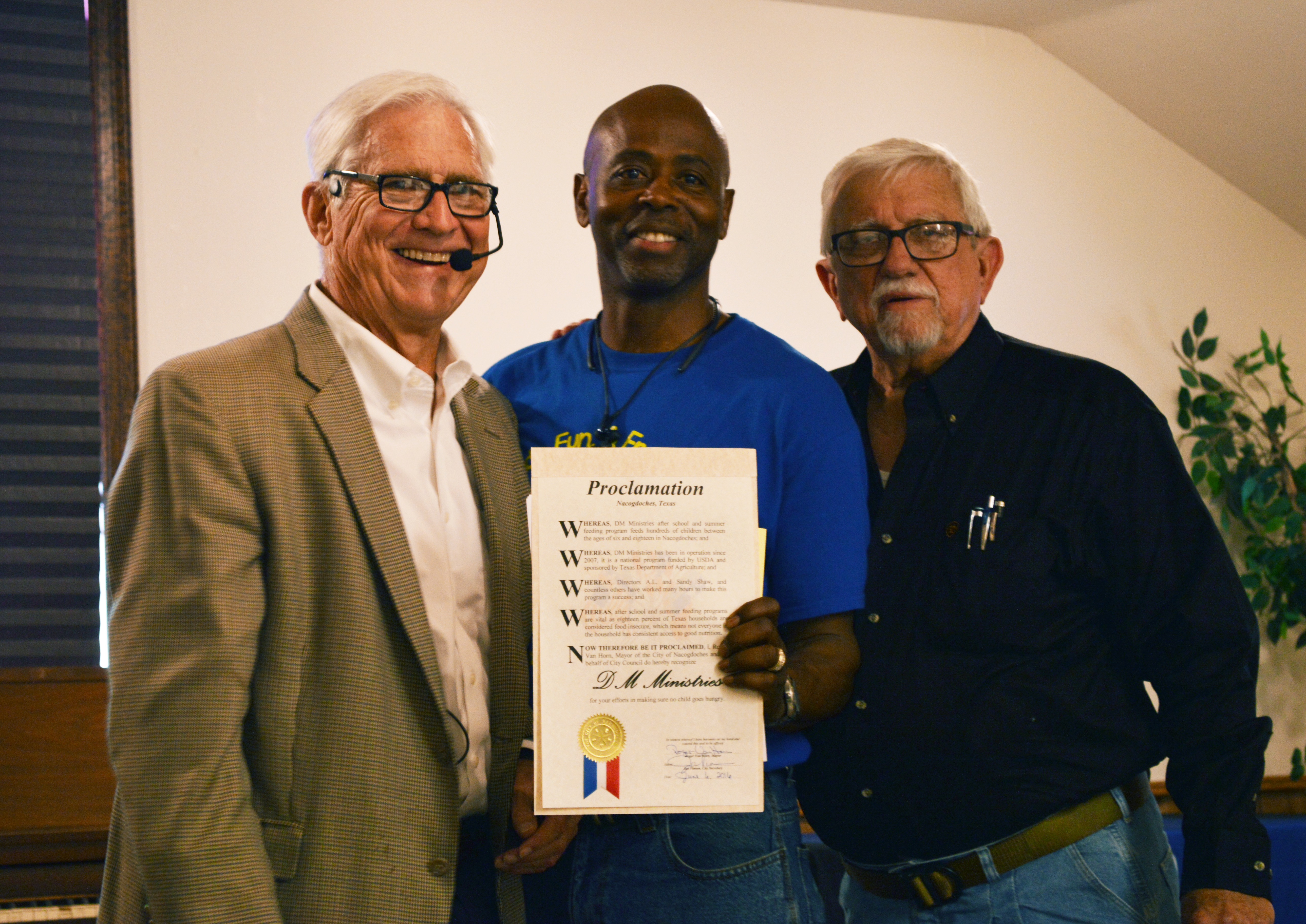 Pastor Al Shaw (pictured at center) of Davis Memorial Church accepts a proclamation from the City of Nachogdoches, supporting the church’s efforts around summer meals.